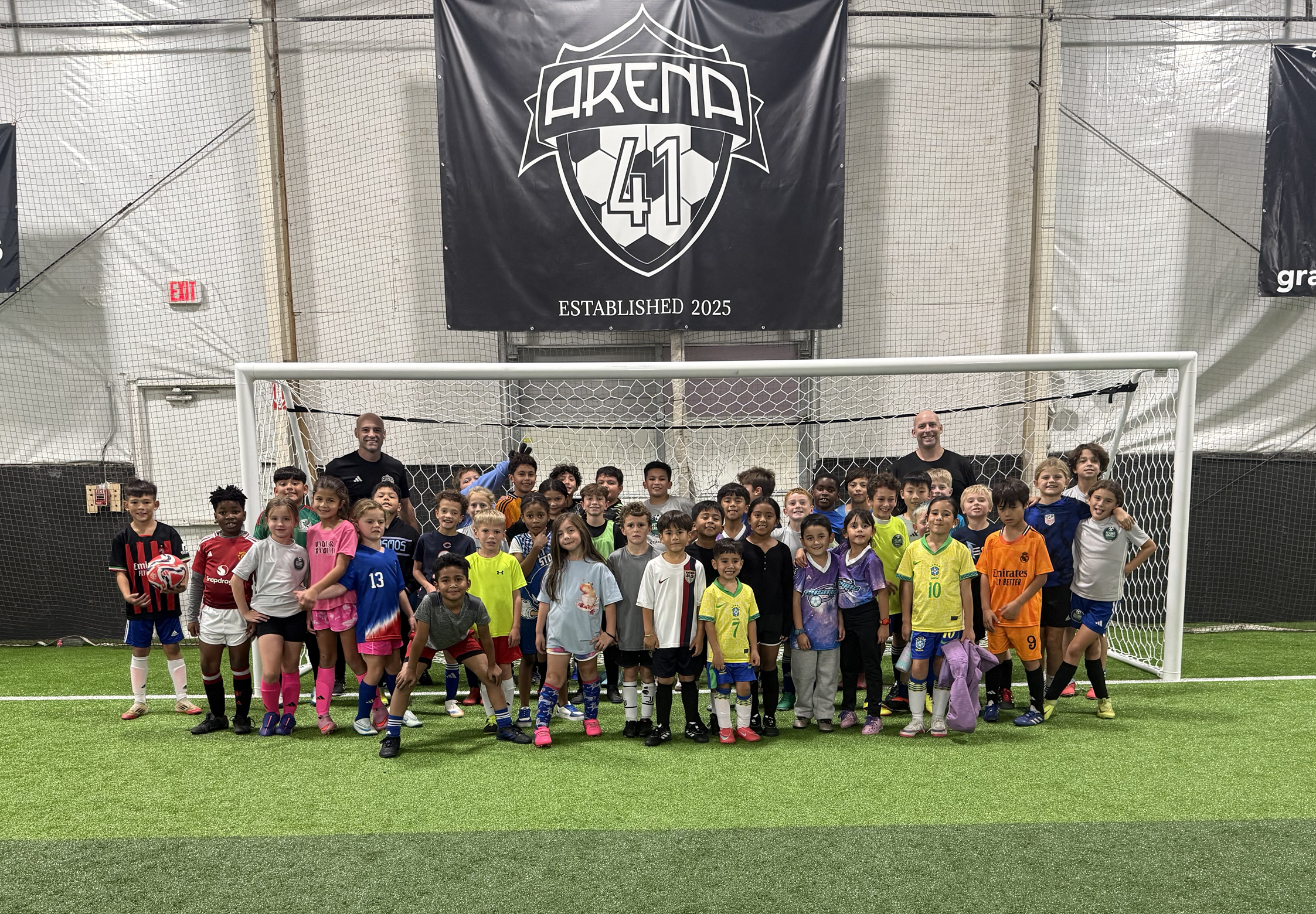 children in front of soccer goal